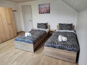 a bedroom with two beds with pillows on them at DAI Apartment in Maribor
