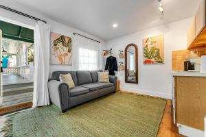a living room with a couch and a window at HIDEAWAY @ Speakeasy Inn Key West! in Key West +12 photos