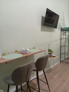 a room with two chairs and a counter with two sinks at Le Suite di Antonella in Taranto