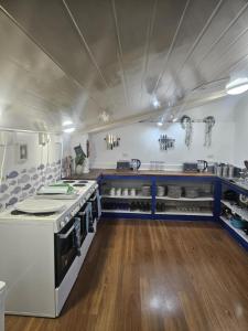 a kitchen with a stove top oven in a room at The Boathouse Lodge in Picton