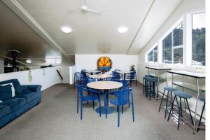 a dining room with blue chairs and a table at The Boathouse Lodge in Picton