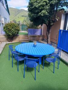 a blue table and four chairs on the grass at The Boathouse Lodge in Picton