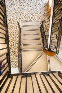 a staircase in a building with a metal door at Hotel Villa Trieste in Sirmione