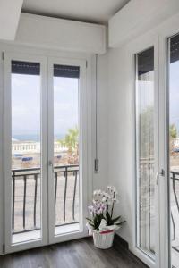 a room with french doors with a view of the ocean at Hotel Villa Trieste in Sirmione +32 photos