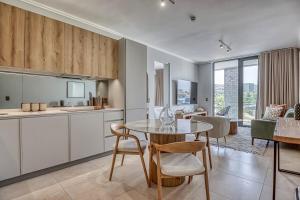 a kitchen and dining room with a table and chairs at Caica Executives at Ellipse 4108 in Midrand