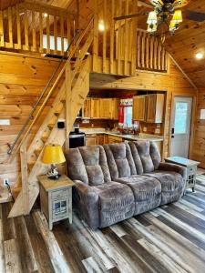 a living room with a large couch in a cabin at Creekside Blessings Cabin in Beech Mountain