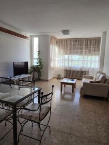 a living room with a couch and a table at Casa LIDIA Hostel in Comodoro Rivadavia