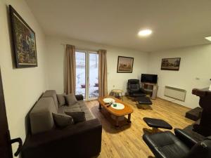a living room with a couch and a table at Planinska kuca Steki Bukulja in Arandelovac +79 photos