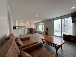 a living room with a couch and a table at Beautiful Waterfront Apartment Quispamsis, NB in Catons Island