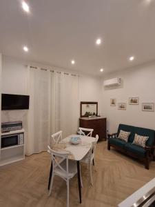 a living room with a table and a couch at Residenza Rivellini Tropea in Tropea
