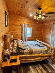 a bedroom with a bed in a log cabin at Creekside Blessings Cabin in Beech Mountain