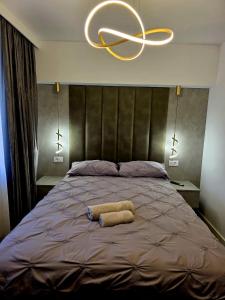 a bed with two towels laying on top of it at Old Town Luxury 1 in Târgovişte
