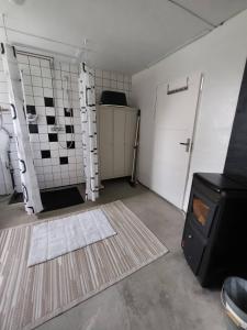 an empty garage with a door and a rug at Hus Indalsälven in Hammarstrand +49 photos