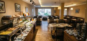 a restaurant with a buffet line with tables and chairs at Kule Rezidance Hotel in Seyhan +14 photos