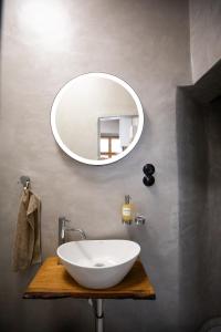 a bathroom with a white sink and a mirror at Residence 1892 - Apartment 3 in Bratislava +19 photos