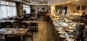 a restaurant with a buffet line with plates of food at Kule Rezidance Hotel in Seyhan