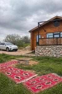 a house with a car parked in front of it at شاليه غصن in Ajloun