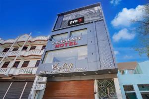 a building with a sign for a hotel at Hotel O J K Galaxy Hotel in Juhi Bari