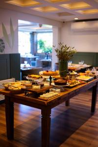 a table with a bunch of food on it at Blumen Hotel Boutique in Canela