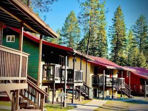 a group of buildings with decks and trees at Bear creek resort in Thompson Falls