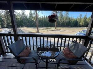 a porch with two chairs and a table on a porch at Bear creek resort in Thompson Falls +3 photos