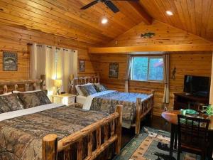 a bedroom with two beds in a log cabin at Bear creek resort in Thompson Falls