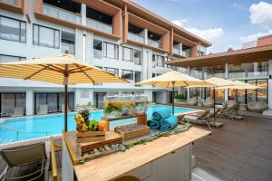 a food stand in front of a building with a pool at LIV Hotel Phuket Patong Beachfront in Patong Beach