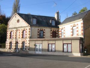 an old brick building with windows on a street at hotel de la bonnaventure in Mazangé