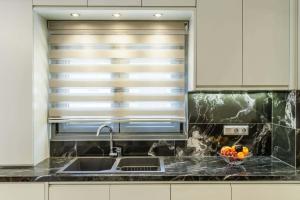 a kitchen with a sink and a window at The Hidden Gem Skopelos - Elegant Island Retreat in Skopelos Town +19 photos