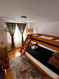 a bedroom with two bunk beds in a room at Wanderlust Cottage Avrig in Avrig
