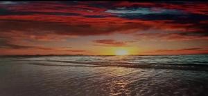 a painting of a sunset on the beach at Blue Haven in Upper Ballycotteen