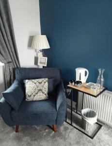 a blue chair in a living room with a table at Blue Haven in Upper Ballycotteen