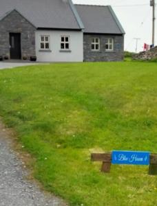 a blue sign on a bench in front of a house at Blue Haven in Upper Ballycotteen