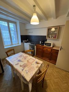 a kitchen with a table and some chairs and a table and a kitchen at hotel de la bonnaventure in Mazangé +22 photos