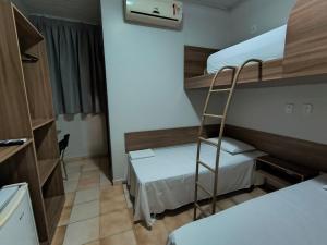 a small room with two bunk beds and a ladder at Hotel do Porto in Porto Velho +21 photos