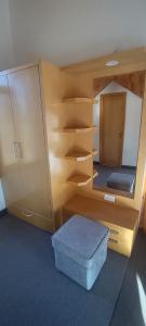 a room with a wooden bunk bed with a blue ottoman at Peaceful huts in Manāli +10 photos