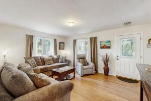 a living room with a couch and a table at 1 Mi to Boat Launch! Lake-View Chiloquin Retreat in Chiloquin