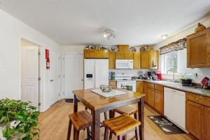 a kitchen with wooden cabinets and a wooden table at 1 Mi to Boat Launch! Lake-View Chiloquin Retreat in Chiloquin