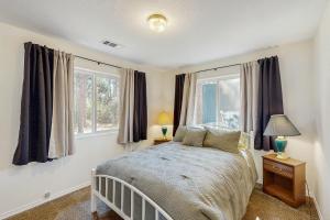 a bedroom with a bed and two windows at 1 Mi to Boat Launch! Lake-View Chiloquin Retreat in Chiloquin
