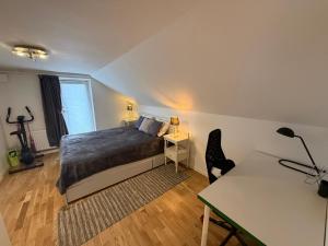a bedroom with a bed and a desk and a desk at Sahlin - Kattarp in Kattarp