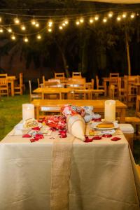 a table with a white table cloth and candles on it at Bungalows Spilberg in Colán