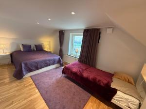 a bedroom with two beds and a window at Sahlin - Kattarp in Kattarp