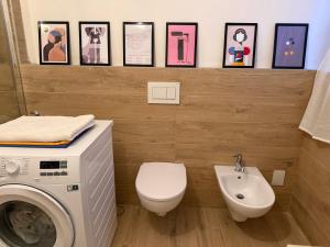 a bathroom with a washing machine and a sink at Residenza Il Castello Uno e Due in CastellʼArquato +75 photos