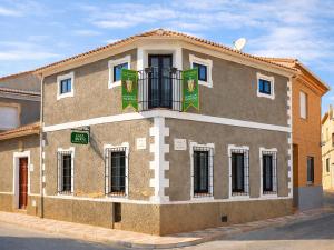 a building with green flags on the side of it at Medieval country house Señorío de Montero in Cenizate