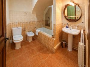 a bathroom with a toilet and a tub and a sink at Medieval country house Señorío de Montero in Cenizate +32 photos