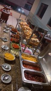 a buffet line with many different types of food at Hotel do Porto in Porto Velho