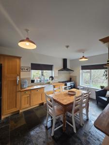 a kitchen with a wooden table and chairs in a room at The Bungalow Killybegs in Killybegs