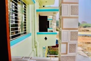 an open door of a building with a window at Sky View Guest House in Shānti Niketan