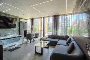 a living room with a couch and a large window at Haven, A Design Hotel in Medellín