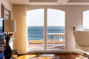 a living room with a view of the ocean at Cascais Lux - New Apartment in Parede